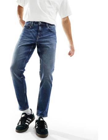 ASOS DESIGN stretch tapered jeans in 90s mid wash