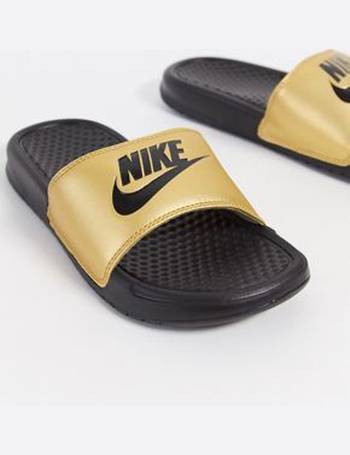 black and gold nike flip flops